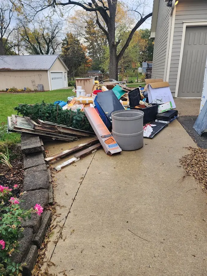 Dumpster being loaded with debris for 3 Yard Dumpster Rental in Candia